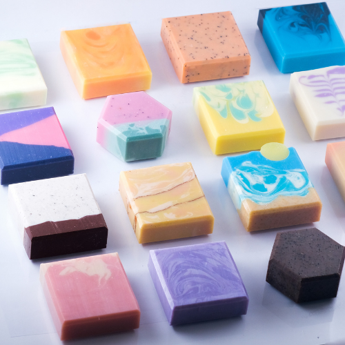 variety of handmade soaps, most are square bars, 2 are hexagon shapes